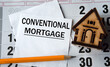 CONVENTIONAL MORTGAGE - word on white paper on the background of a house, pencil and calendar