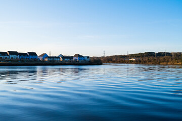 Wall Mural - Blaydon UK: 2nd April 2022: River Tyne in Newcastle during golden hour with clear blue skies