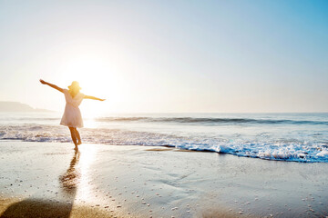 young woman having fun walking on seaside.