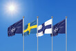 Leinwandbild Motiv Flags of NATO - North Atlantic Treaty Organization, Finland, Sweden.  - 3D illustration.  Isolated on sky background.