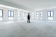 © xy - A man standing in empty office