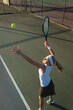 High angle view of caucasian young female player serving during tennis game at court