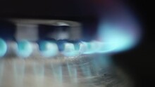 Macro CloseUp Shoot of Gas Burner with Blue Flame Fire. Slow Motion Footage. Light of Gas Cooker Manually or Automatically. Fossil Burning, Heating Energy. Natural gas inflammation.
