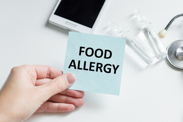 Wall Mural - the doctor's hands holds a business card with the text of Food Allergy