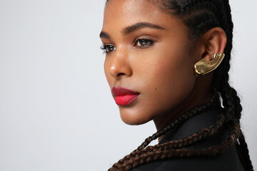 Gorgeous African American woman with long braids posing in the studio. Isolated.