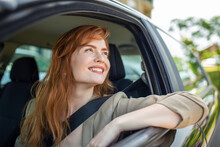 Beautiful Young Woman Driving Her New Car At Sunset. Woman In Car. Close Up Portrait Of Pleasant Looking Female With Glad Positive Expression, Woman In Casual Wear Driving A Car