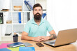 © be free - Serious professional man sitting at office desk, manager