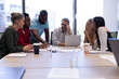 © WavebreakMediaMicro - Multiracial businessmen and businesswomen discussing strategy during meeting in boardroom at office