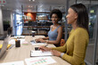© wavebreak3 - African american businesswomen working together in modern workplace