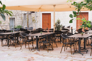 retro style tables and chairs at cafe outdoor terrace, vintage atmosphere, dining time, relax and leisure patio concept