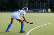 Young field hockey female player waiting for penalty shot.