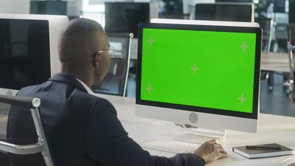 Business African-American Man Working Internet on Computer On Desk. Man Surfing on PC with Green Screen Notebook. Close Up Male Freelancer Searches For Information on The Internet