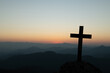 cross crucifixion of the crucifixion of jesus christ on a mountain with a sunset background