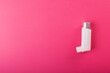 Directly above shot of white asthma inhaler isolated against pink background, copy space