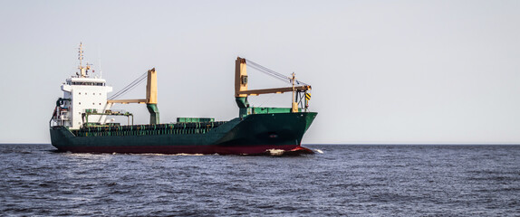 Floating cargo ship at sea. Freight transport by sea