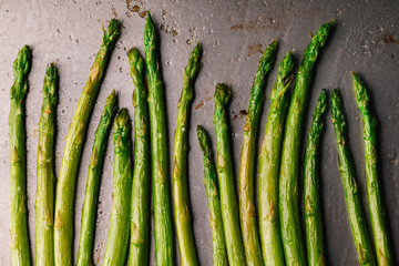 Overhead view of roasted asparagus on a baking tray