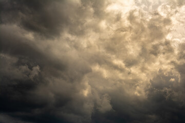 Wall Mural - dramatic mystical sky with dense clouds and back sunlight. artistic picture for the original background, layout or decoration