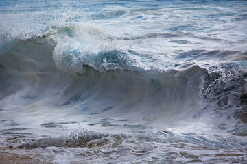 Wall Mural - ocean shorebreak waves covered with white foam