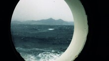 A Ship In A Storm At Sea, High Waves Shake The Ship, The View From The Porthole Window, High Waves, The Ship Is Moving