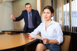 Angry businessman boss firing upset asian female employee in office