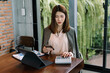 © Nuttapong punna - Portrait of female office businesswoman startup daydreaming about her work, startup and working with laptop on office desk in office room sitting at coffee shop.