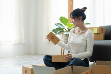 Wall Mural - Portrait of Starting small businesses SME owners female entrepreneurs working on receipt box and check online orders to prepare to pack the boxes, sell to customers, sme business ideas online