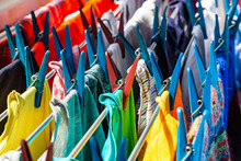 Multi-colored Clothes Hang Attached To Clothespins And Dry After Washing, Close-up.