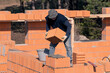 © сергей назаров - The builder lays bricks on the wall. Bricklaying. Bricklayer builder, private master. Construction of a cottage, a country house.