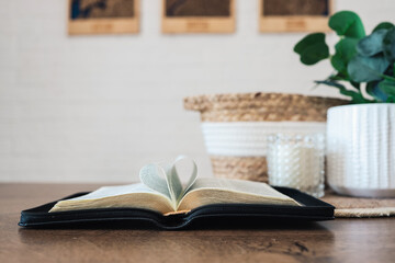 Wall Mural - Open Bible with heart-shaped pages on a table with beautiful decor, morning reading of the Word, God is love