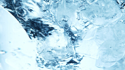 Canvas Print - Close up of ice cubes underwater, blue background.