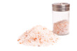 Pink Himalayan salt crystals in a glass grinder isolated on white background