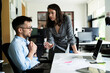 © JustLife - Colleagues arguing in office. Angry businesswoman yelling at her collegue