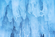 Blue Ice And Icicles On The Rocks Of Ogoy Island, Baikal Lake, Siberia, Russia. Abstract Winter Nature Background.