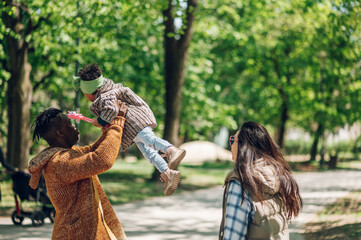 Wall Mural - Multiracial family having fun in the park