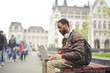 © olly - young man with laptop on a bench in the city