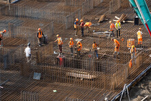 Workers Working With Concrete Irons In A Construction Site