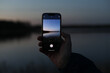 © paralisart - hand holding smart phone and taking photo of beautiful sunset