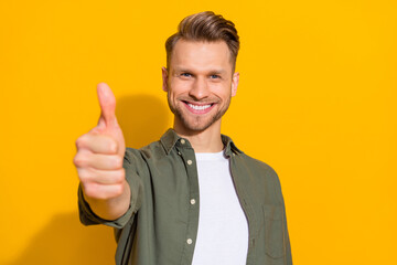 Sticker - Portrait of attractive cheerful content guy giving thmbup ad advert isolated over bright yellow color background