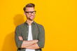 Leinwandbild Motiv Portrait of attractive cheerful content guy folded arms thinking copy empty space isolated over bright yellow color background