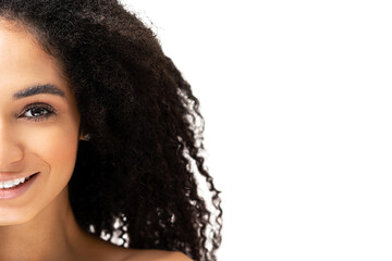 Wall Mural - Half-face portrait of elegant beautiful young African -American woman, gorgeous and bright multiracial lady looks at the camera with smiling face, pure smooth skin. Face and body care