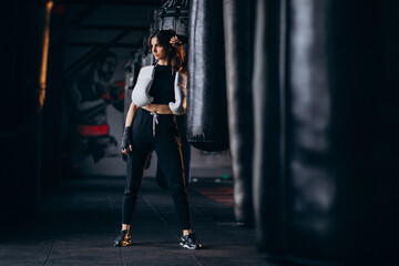 Young woman boxer training at the gym