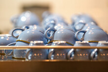 Close-Up Of Coffee Cups On Top Of A Coffee Machine In A Cafe