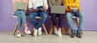 © Studio Romantic - Student lifestyle. Young people with laptops and notebooks sitting in row on chairs on background of purple wall. Legs of students in casual clothes who use manuals and gadgets to prepare for exam.