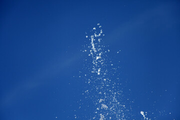 Wall Mural - Water splashing from the fountain in the background of blue sky