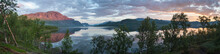 Panoramic View Of Beautiful Blue Pink Sunrise Over The Lake Dam On River Lulealven In Saltoluokta In Sweden Lapland. Reflection Of Pink Mountains And Sky With Dramatic Clouds In Clear Calm Water.