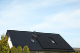 Fototapeta Kawa jest smaczna - House with installed solar panels on roof, space for text. Alternative energy