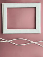 Sticker - Horizontal art frame and pearl jewellery on blush pink background as flatlay design, artwork print or photo album