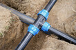 Installed PVC water pipes in trench at construction site