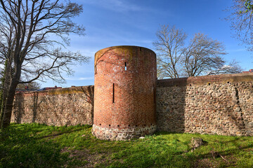 Canvas Print - medieval fortifications with a round tower and a stone wall in Neuebrandemburg