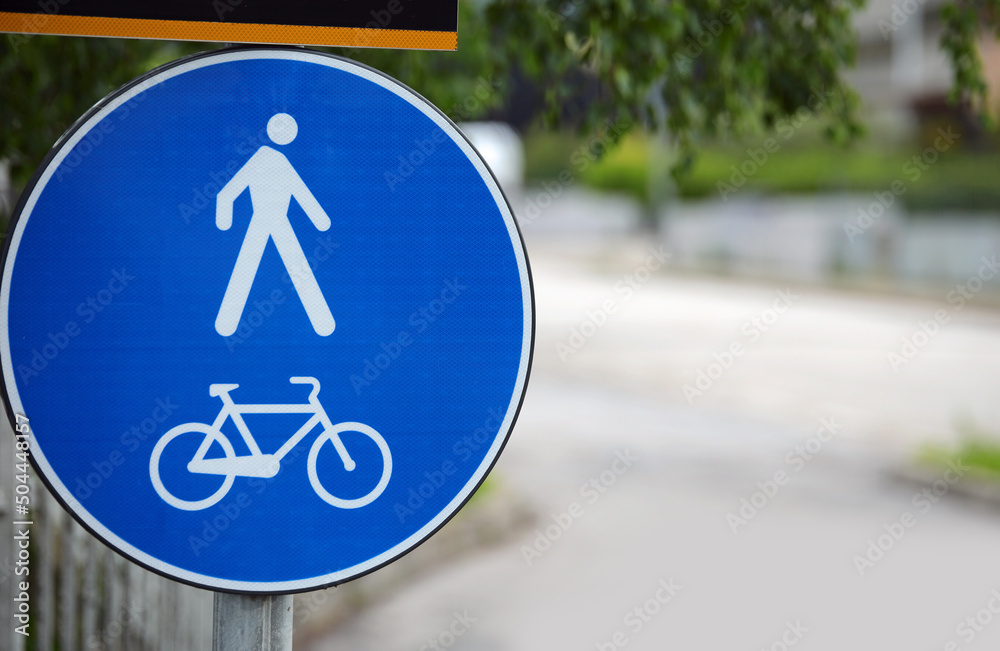 Road sign with two symbols that means pedestrian zone and cycle path ...